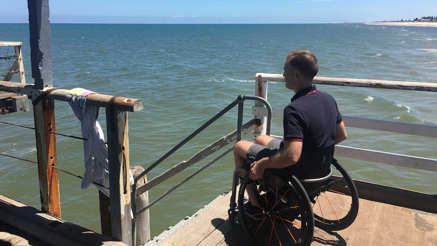 Ryan Mann in a wheelchair on Henley jetty.