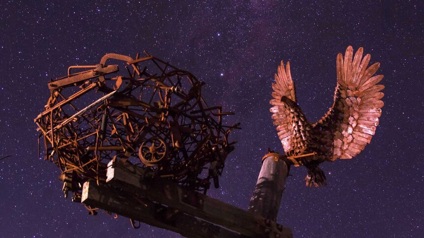 Sculpture rises into night sky
