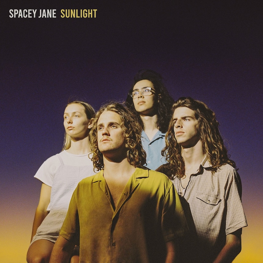 Portrait photograph of the four members of Spacey Jane looking into the distance against a sunset