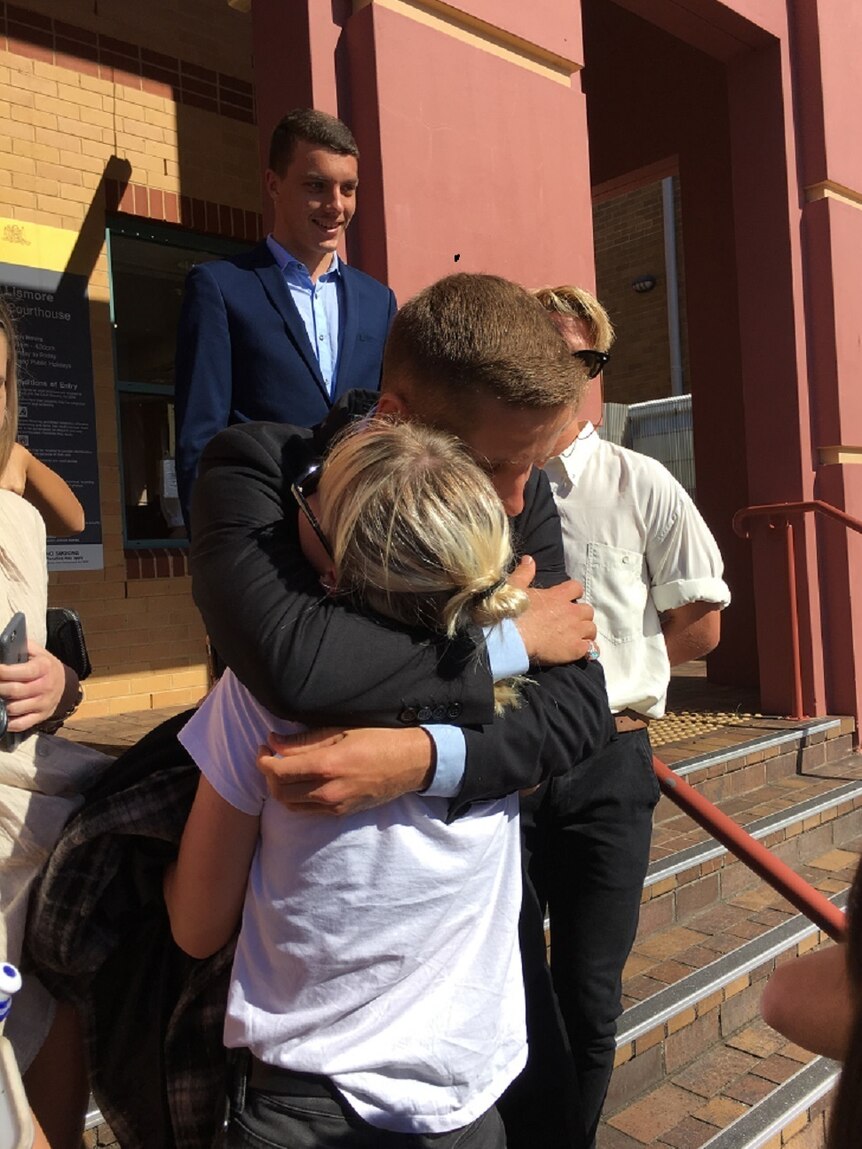 Byron Bay teenager, Flynn Brown hugs friends after appearing in the Lismore Court on drug charges.