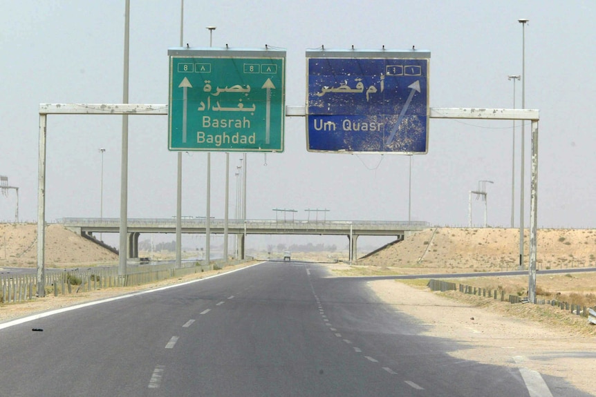 Signs for Baghdad and Um Qasr on the highway.