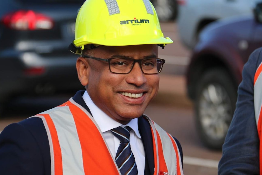 Smiling Sanjeev Gupta in a hard hat and safety vest.