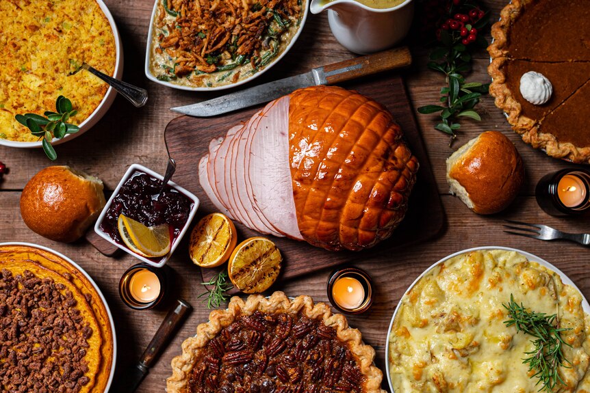 An image of Christmas lunch with ham, turkey and plenty of sides. 