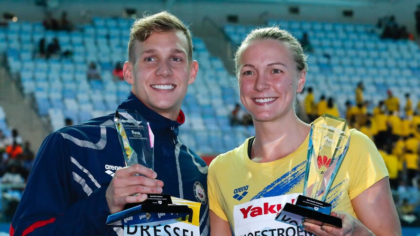United States' Caeleb Dressel, left, and Sweden's Sarah Sjsotrom pose with their trophies.