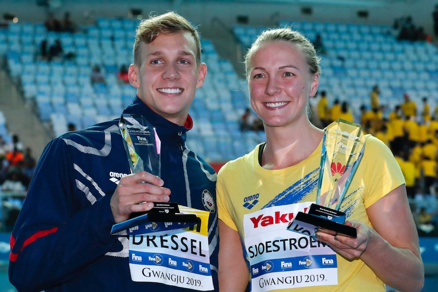 United States' Caeleb Dressel, left, and Sweden's Sarah Sjsotrom pose with their trophies.