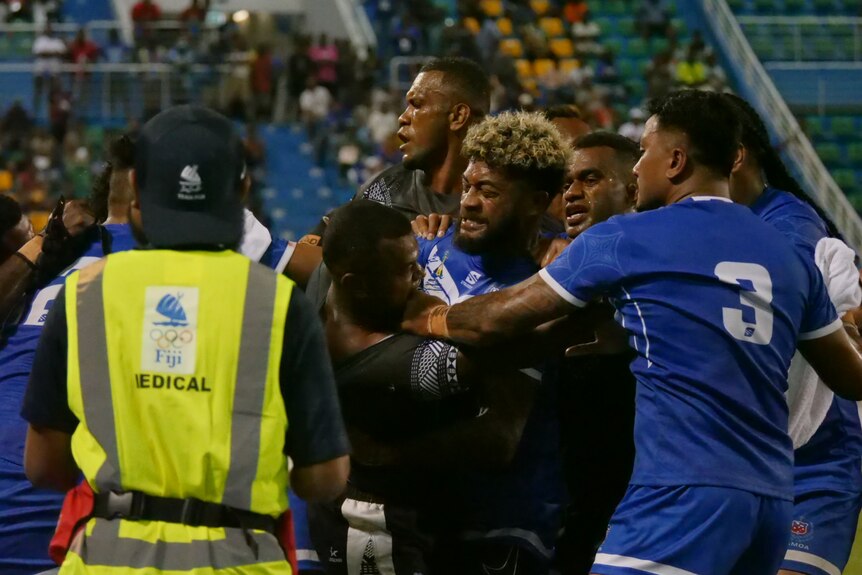Samoan and Fiji players tussle after the match.