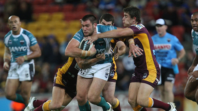 Tight contest ... Tim Grant tries to break the Broncos' defence