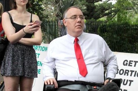 MP Rob Pyne in his wheelchair at a media event outside state parliament in Brisbane