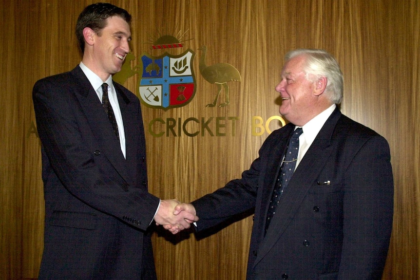 Denis Rogers shakes hands with James Sutherland on becoming the new chief executive of the ACB in Melbourne in 2001.