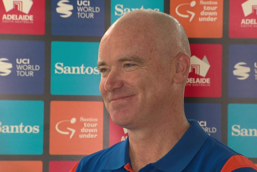 A headshot of a man smiling