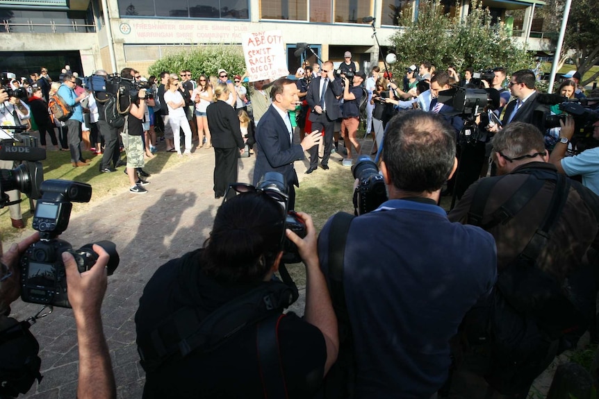 Tony Abbott is surrounded by onlookers as he addresses media in his electorate of Warringah.