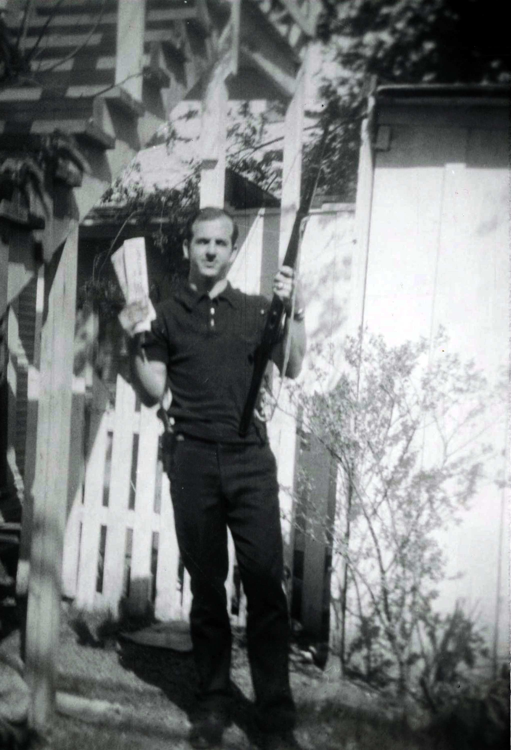 Lee Harvey Oswald holding rifle and "Communist newspapers"