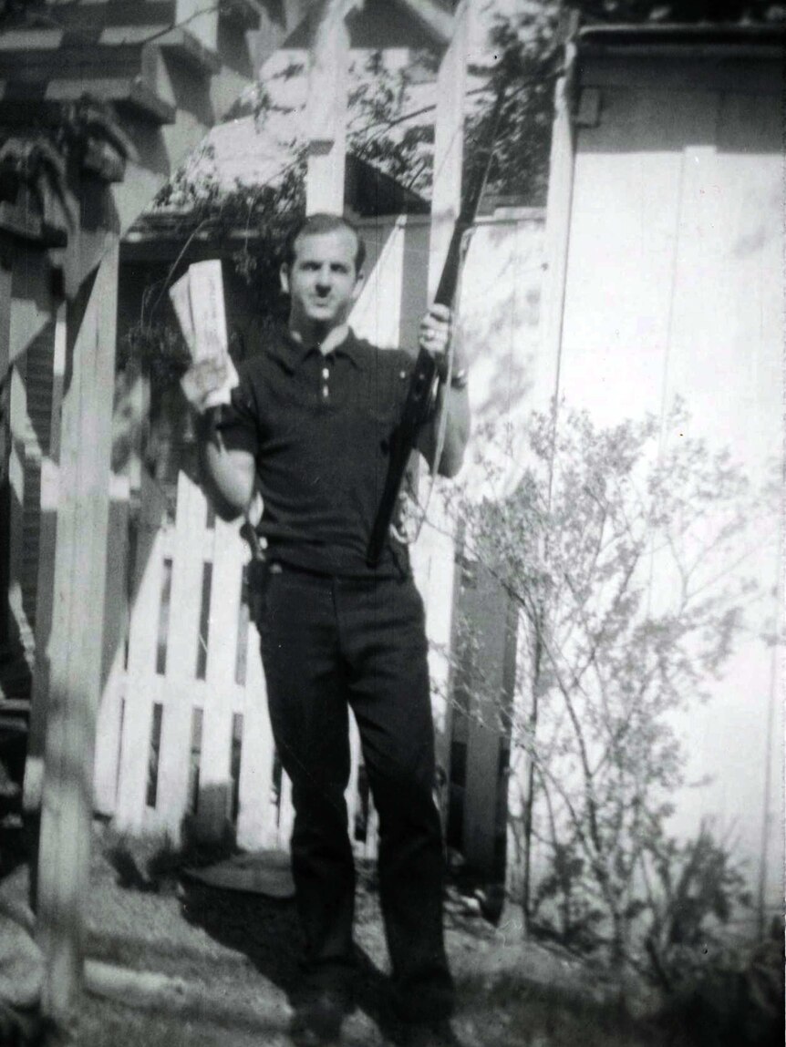 Lee Harvey Oswald holding rifle and "Communist newspapers"