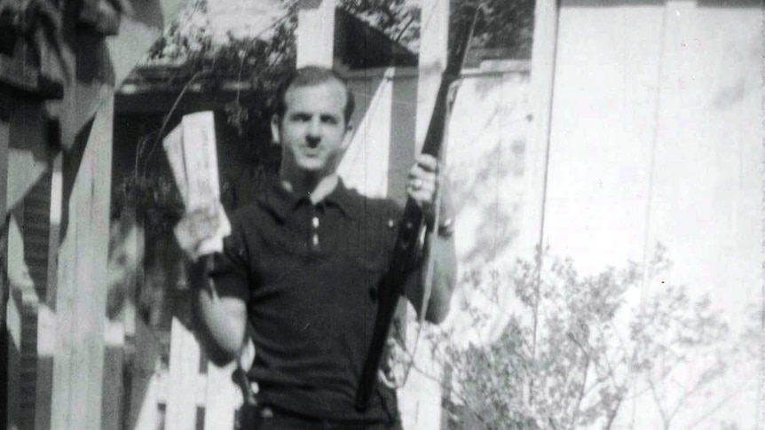 Lee Harvey Oswald holding rifle and "Communist newspapers"