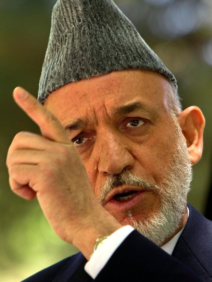 Hamid Karzai gestures as he speaks during a news conference.