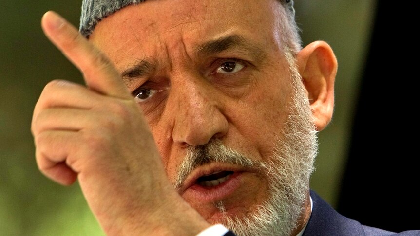 Hamid Karzai gestures as he speaks during a news conference.
