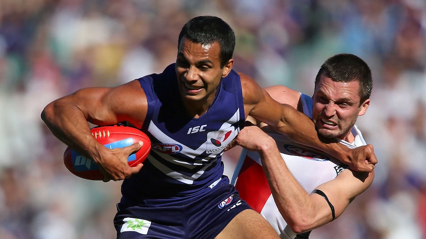 Jarryn Geary of the Saints tackles Danyle Pearce of the Dockers at Subiaco Oval.