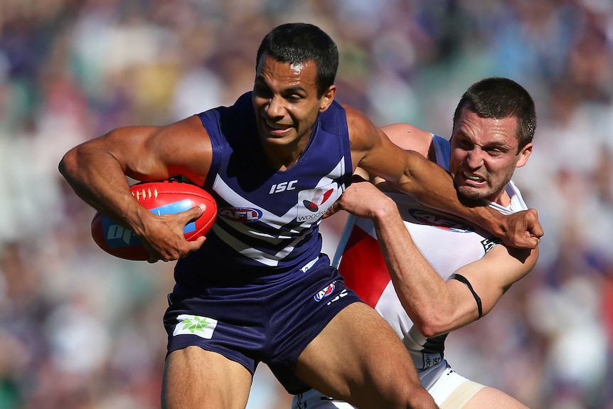Jarryn Geary of the Saints tackles Danyle Pearce of the Dockers at Subiaco Oval.
