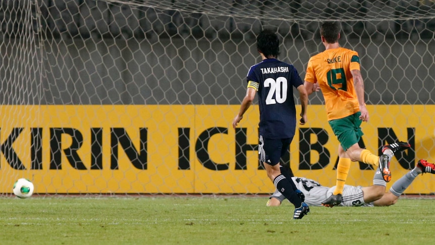 Australia's Mitchell Duke (R) scores against Japan in the East Asian Cup in Hwaseong.