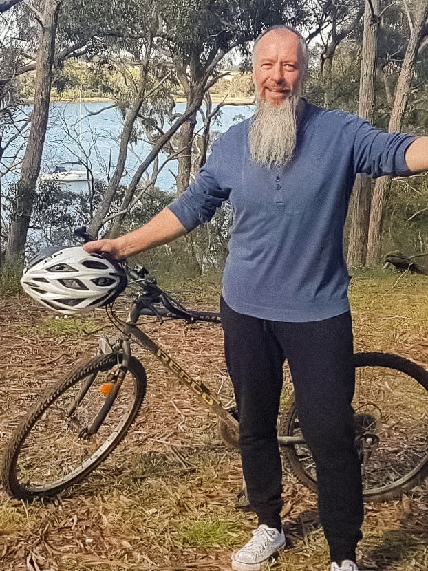 Grant Ottaway standing next to his bike