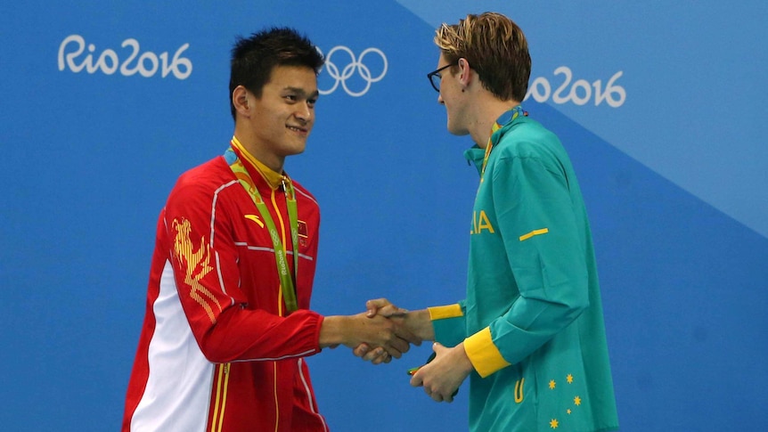 Mack Horton and Sun Yang shake hands during the men's 400m freestyle medal ceremony, August 7, 2016