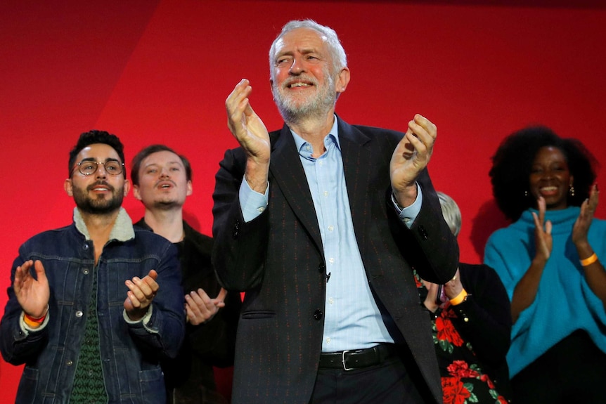 Jeremy Corbyn clapping in front of a group of supporters