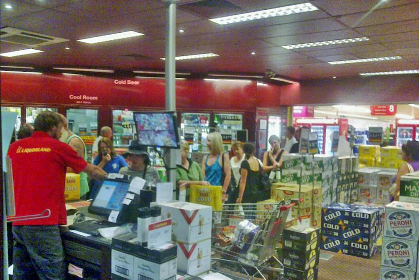 A queue forms late in the afternoon, 5 to 5, at a Kunununurra bottle shop due to liquor restrictions