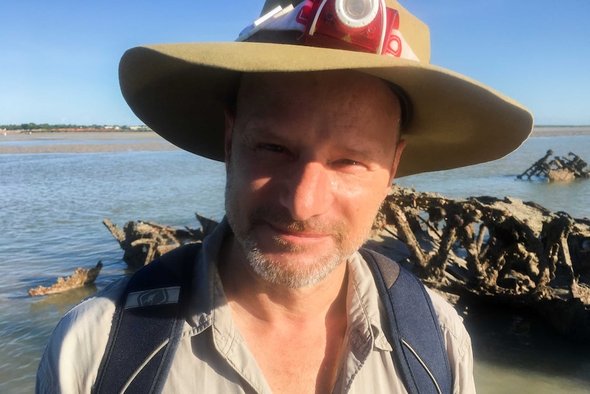 A photo of Dr Silvano Jung at the flying boat wrecks in Roebuck Bay.