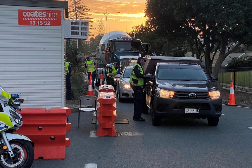 police stopping trucks and cars at border crossing