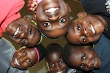 The African Children's Choir visited an AFL match and learnt the Collingwood song so they could get amongst the action.