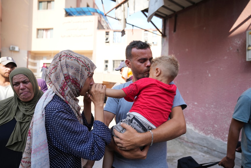 Palestinian parents say goodbye to their sick son before leaving the Gaza Strip 