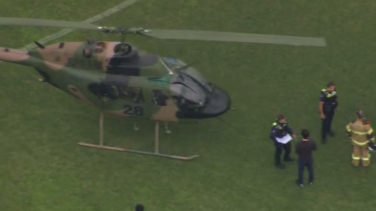 A helicopter landed on an oval.