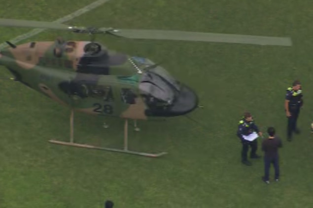 A helicopter landed on an oval.