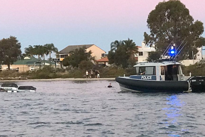 Water police attend a capsized pontoon in the Mandurah Estuary