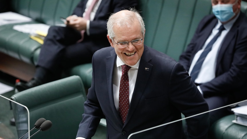 Scott Morrison standing in Question Time smiling