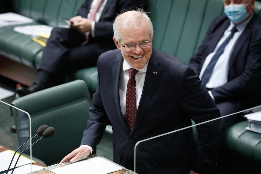 Scott Morrison standing in Question Time smiling