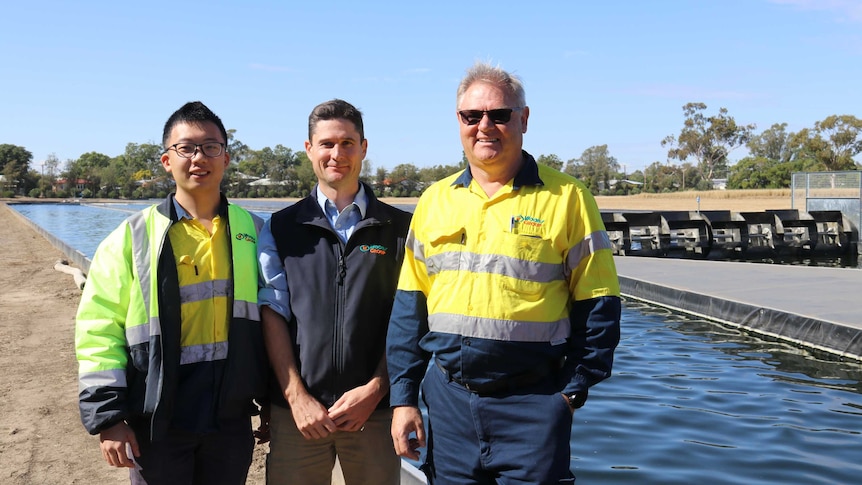 Kai Chen, Tom Woods and Steve Strutt standing in front of one of the algae ponds at Goondiwindi, May 2020.