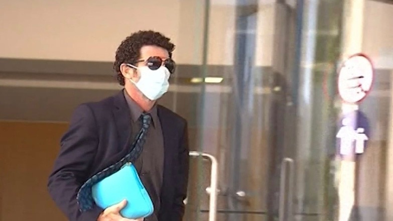 Justin Millington wearing sunglasses and a mask. 