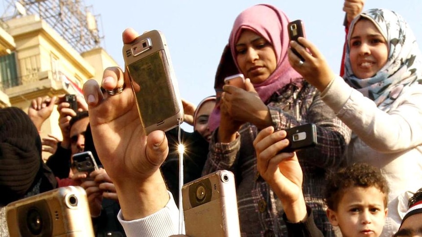 Egyptians use their mobile phones in Cairo's Tahrir Square