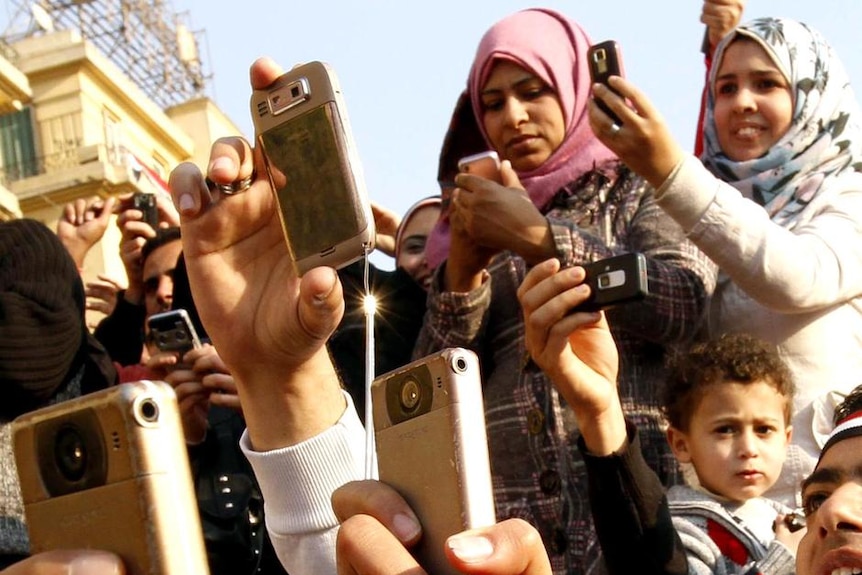 Egyptians use their mobile phones to record goings-on in Cairo's Tahrir Square (AFP: Mohammed Abed)