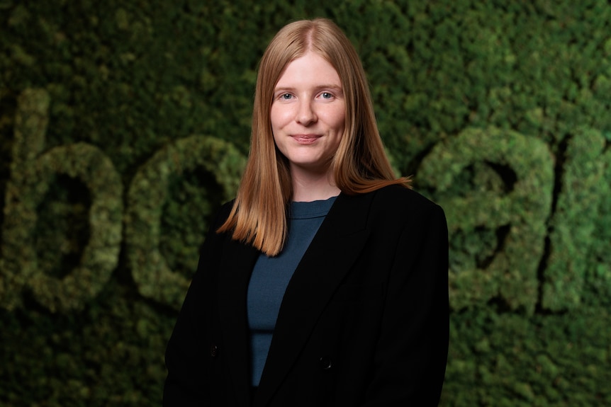 A head and shoulders image of a woman with fair hair in front of a RaboBank sign.