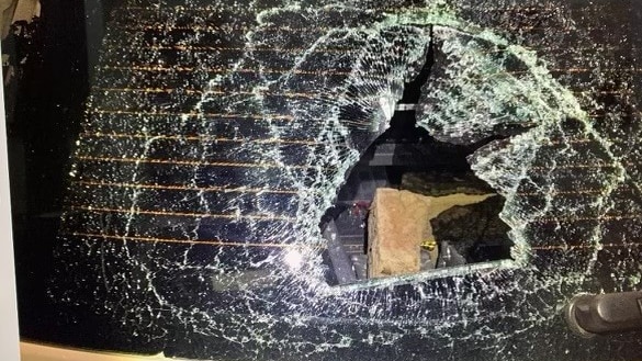 A smashed window on a mobile speed camera car.