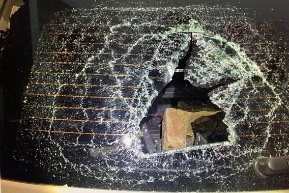 A smashed window on a mobile speed camera car.