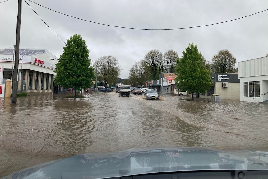 a photo taken from a car of flooding in the main street