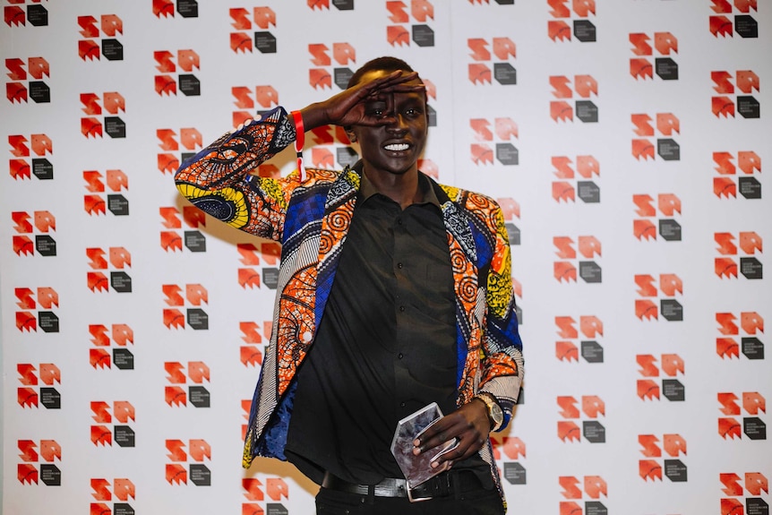 DyspOra stands in front of SA Music awards signage with his Best Male Artist trophy