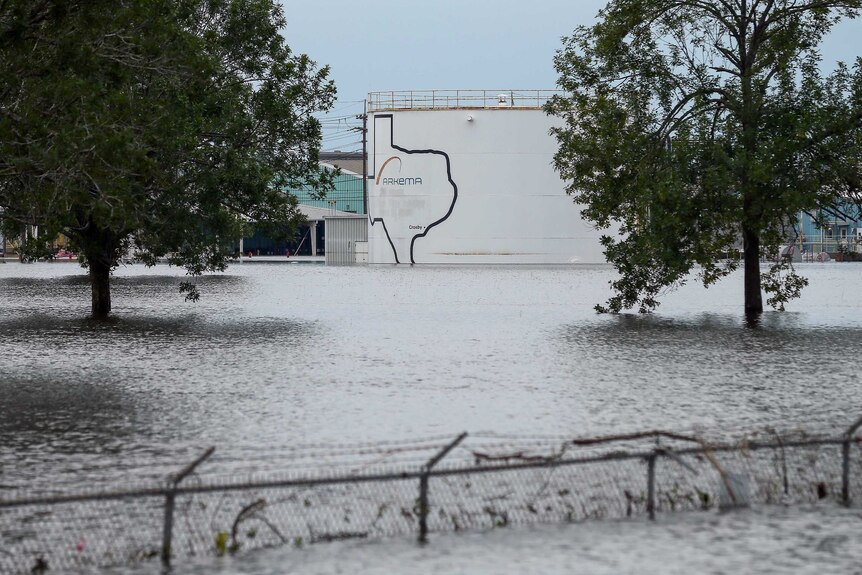 Photo taken from outside the Arkema chemical plant. The water is very high, reaching the top of a barbed wire cyclone fence.