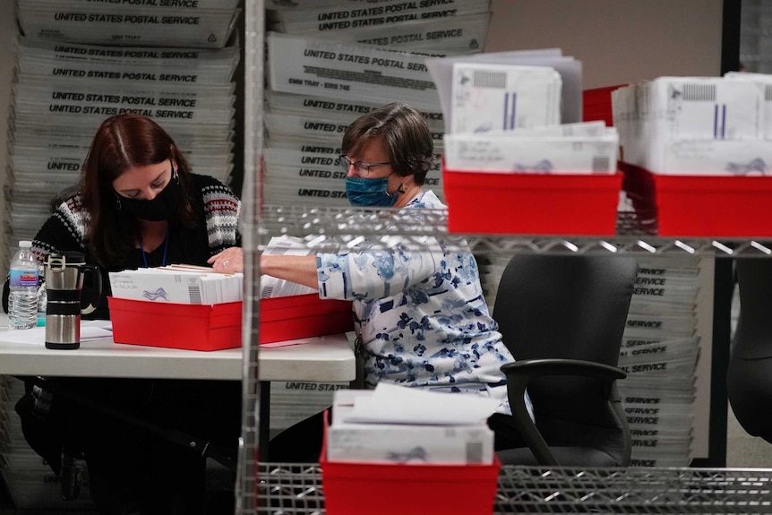 US officials count ballots out of a red box in Pennsylvania.