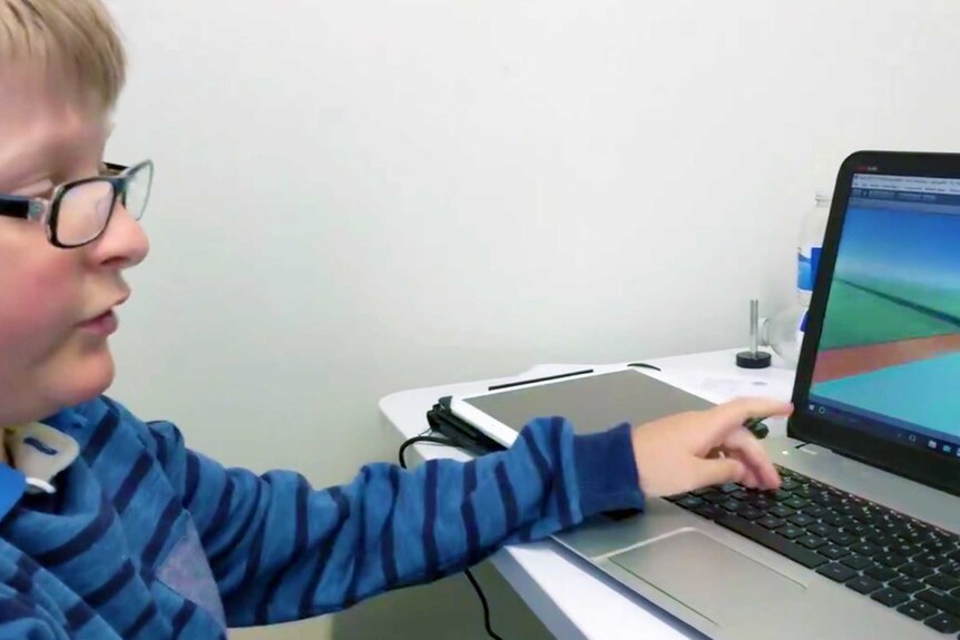 Young person sits at computer