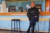 Woman sits in a bar