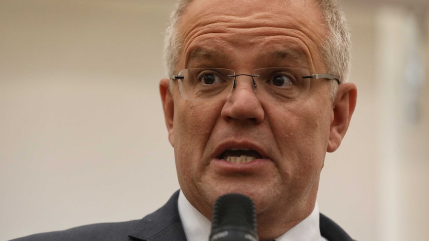 Prime Minister Scott Morrison speaks into a microphone at a campaign event during the federal election.